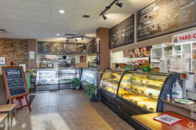 Gourmet Deli House showcases desserts and deli meats in Lantana.