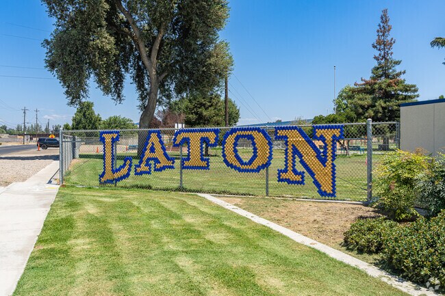 A large fence sign is featured at the entrance to Laton Elementary School.