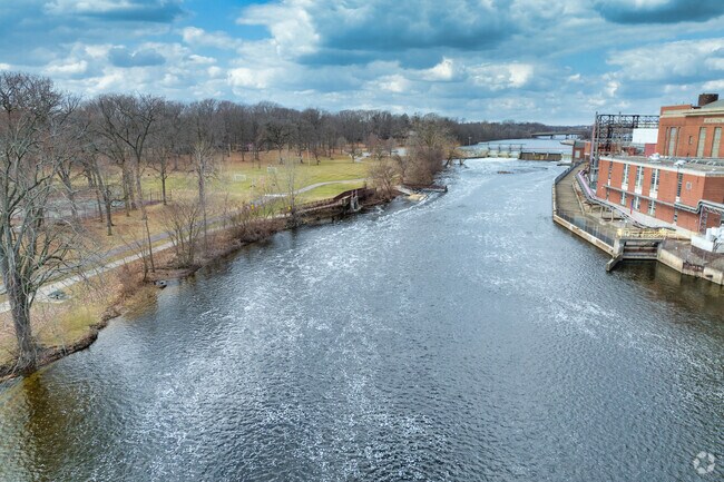 The Lansing River Trail runs along the Grand River in Moores Park, near Greencroft Park.