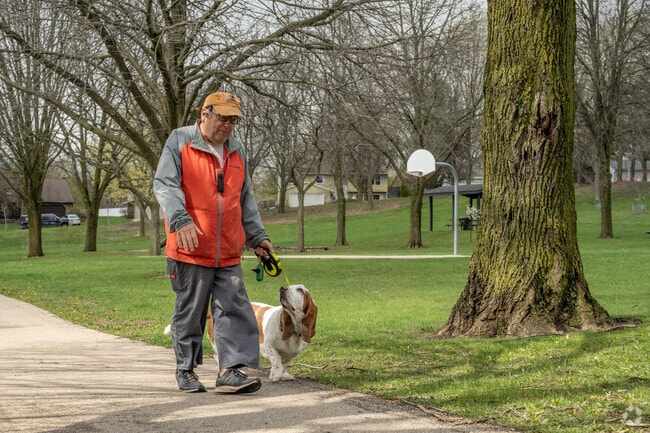 The streets and parks of Prairie Hills are lined with sidewalks and mature trees.