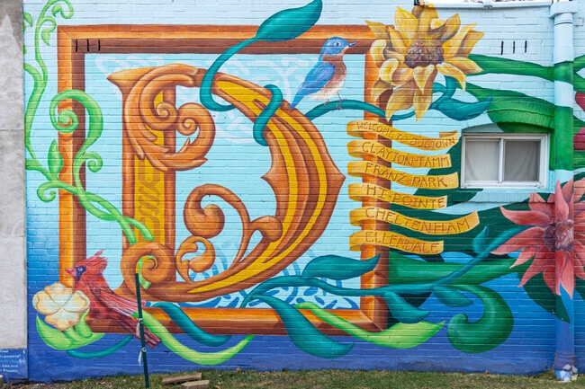 Artwork on a brick wall in Clayton-Tamm depicts their connection to the larger Dogtown.