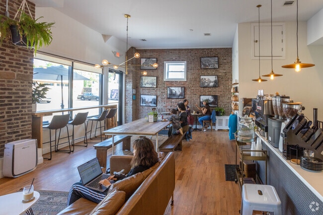 Art work is displayed on the walls in Plainfield's Queen City Coffee Roasters.