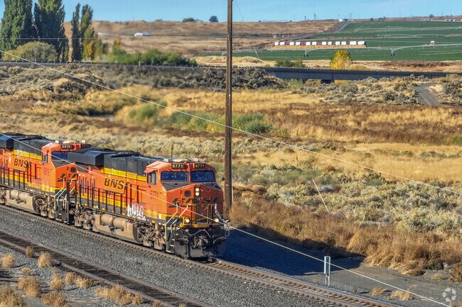 A BNSF train rolls through Basin City, connecting farmland to distant markets.