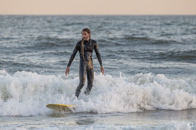 Surfers love the waves at the Atlantic City beach.