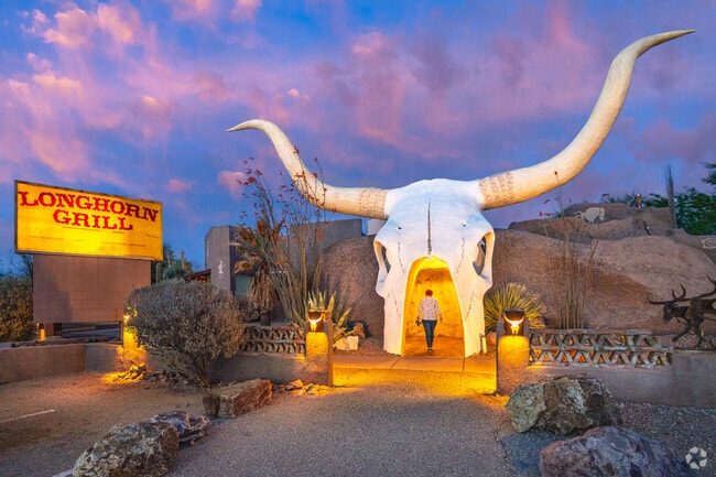The iconic Longhorn Grill and Saloon entrance, marked by its distinctive oversized steer skull, welcomes visitors with an authentic Western charm unique to the region in Green Valley.