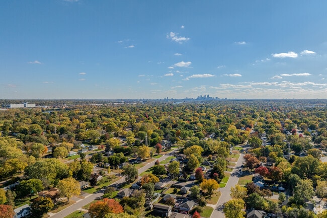 Tree-lined streets in Grandview show fall colors and midcentury homes.