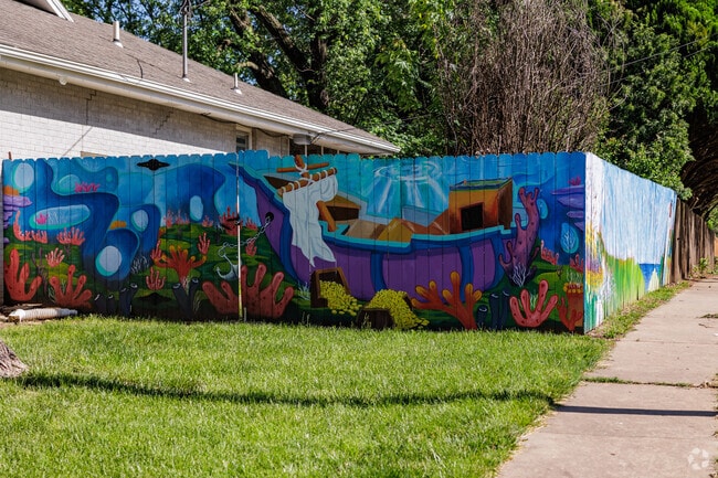 A brightly painted fence welcomes visitors to the Brentwood neighborhood.