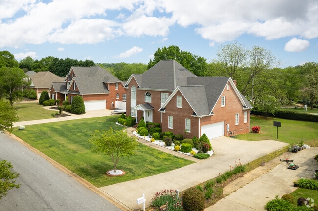 Large brick 2-story houses have large front yards in Hillbrook.
