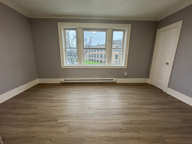 Bedroom 1 (Street-Facing Windows)- Large primary bedroom with full closet and street-facing views.