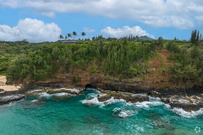 Surrounded by towering cliffs and lush greenery, Kauapea Beach offers stunning panoramic views.