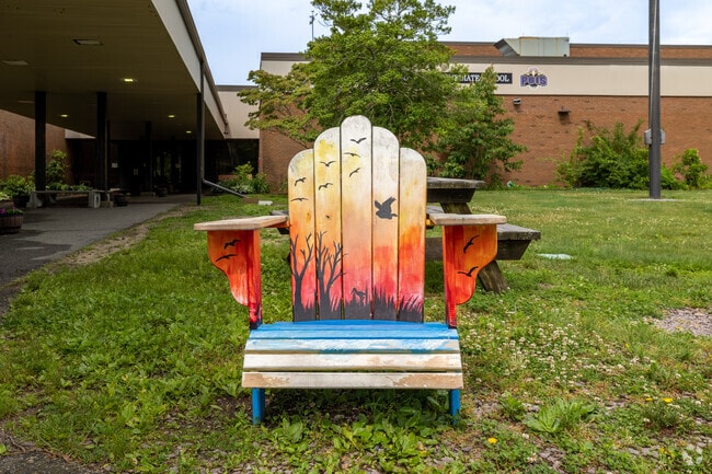 A painted Adirondack chair greets you to Plymouth Community Intermediate School in Plymouth.