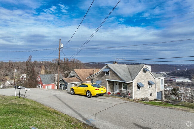 There are some houses in Fallowfield Township situated below the road.