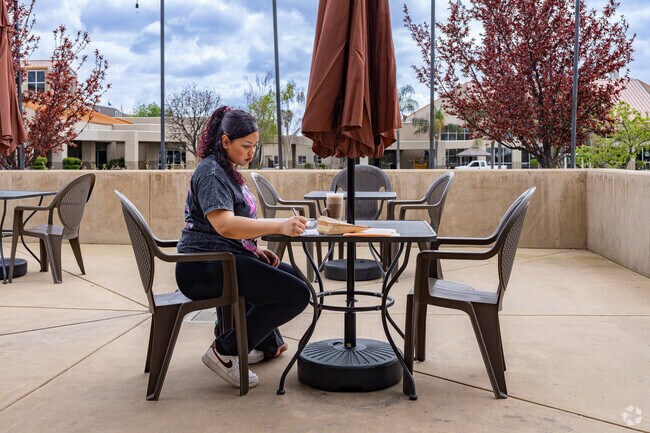 A City in the Hills student works on her homework while enjoying her drink at Summit Coffee.