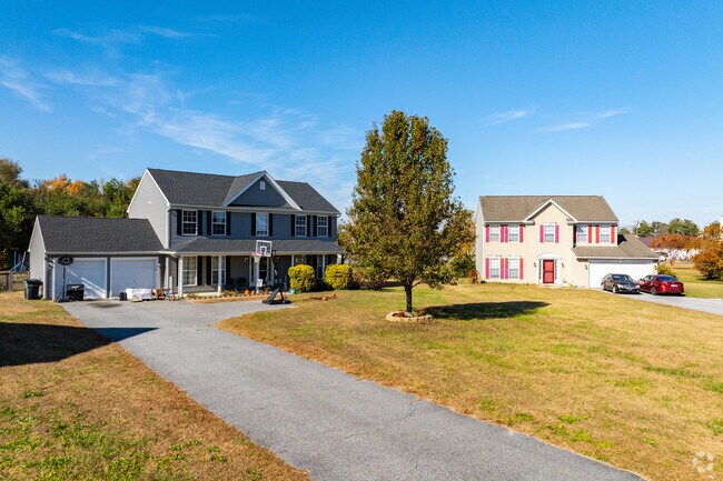 This lovely home features a long driveway and an expansive yard for outdoor enjoyment.