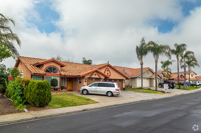 A row of Mediterranean-style homes lines a residential street in Chaparral Hills.
