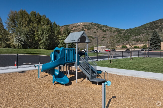 The mountains behind McPolin Elementary are marked with the letters PC for Park City.