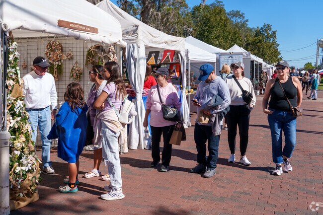 Locals enjoy browsing artwork at the Longwood Arts and Crafts Festival.