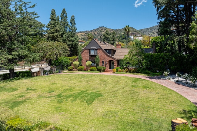 Situated on spacious lots, Brockmont's Tudor mansions offer manicured gardens and panoramic views of the Verdugo Mountains, providing a serene and picturesque setting.