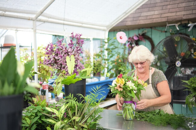 Lovell’s Nursery employees arrange fresh flowers near Fountainhead-Orchard Hills.