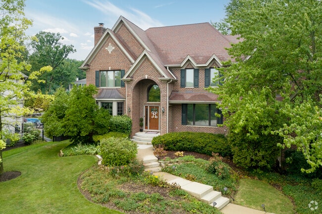 Large red brick homes, tucked behind trees add to the charm of South Barrington.