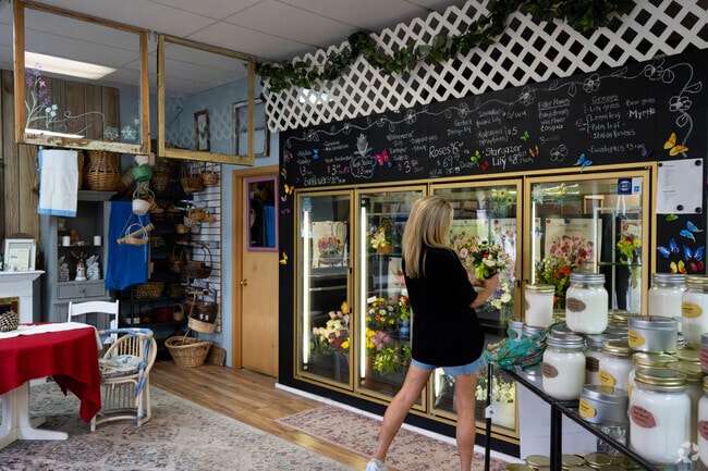 A local customer stops to smell the roses while browsing bouquets at a florist in Centerville, Minnesota.
