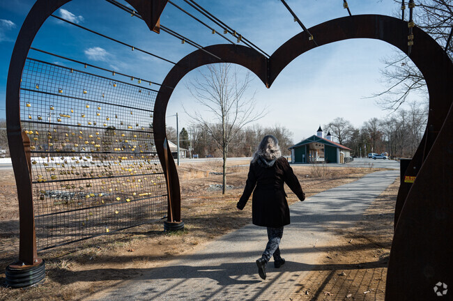 Visitors walk under the heart-shaped arch at Putnam River Trail.