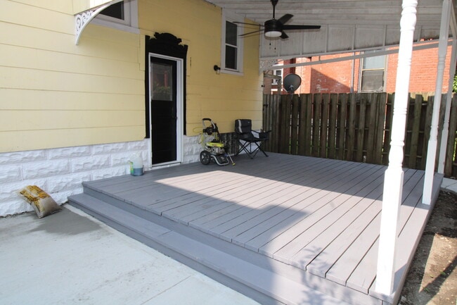 Private covered patio leads to ground level patio.