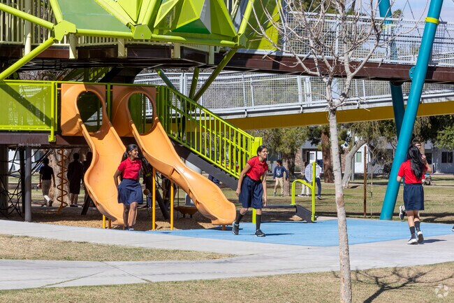 Local school children play at the playground in Pioneer Park in Mesa.