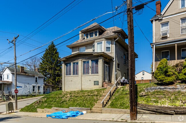 Grand estates sit up above the streets of Beltzhoover looking down at residents as they walk by.