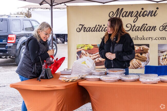 An woman decides between various Italian baked goods at the Montgomery Farmers Market.