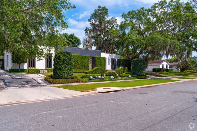 Mature trees and unique architecture line this charming row of Rose Isle homes.