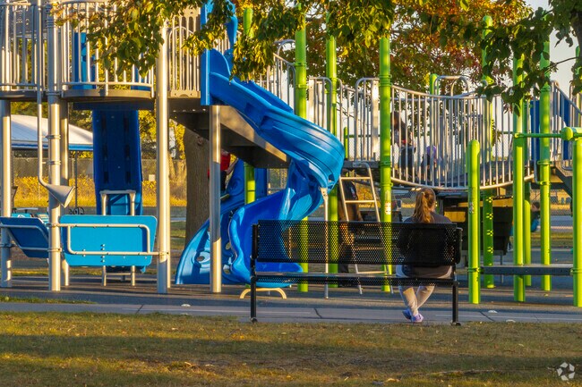 you can sit on a bench and watch your kids play at Alexander Park.