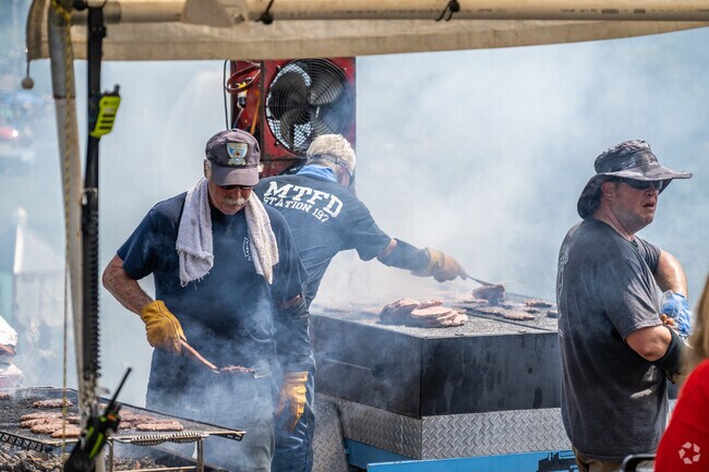 Firefighters grilled hamburgers during the 2024 Annual Car Cruise in Crescent.
