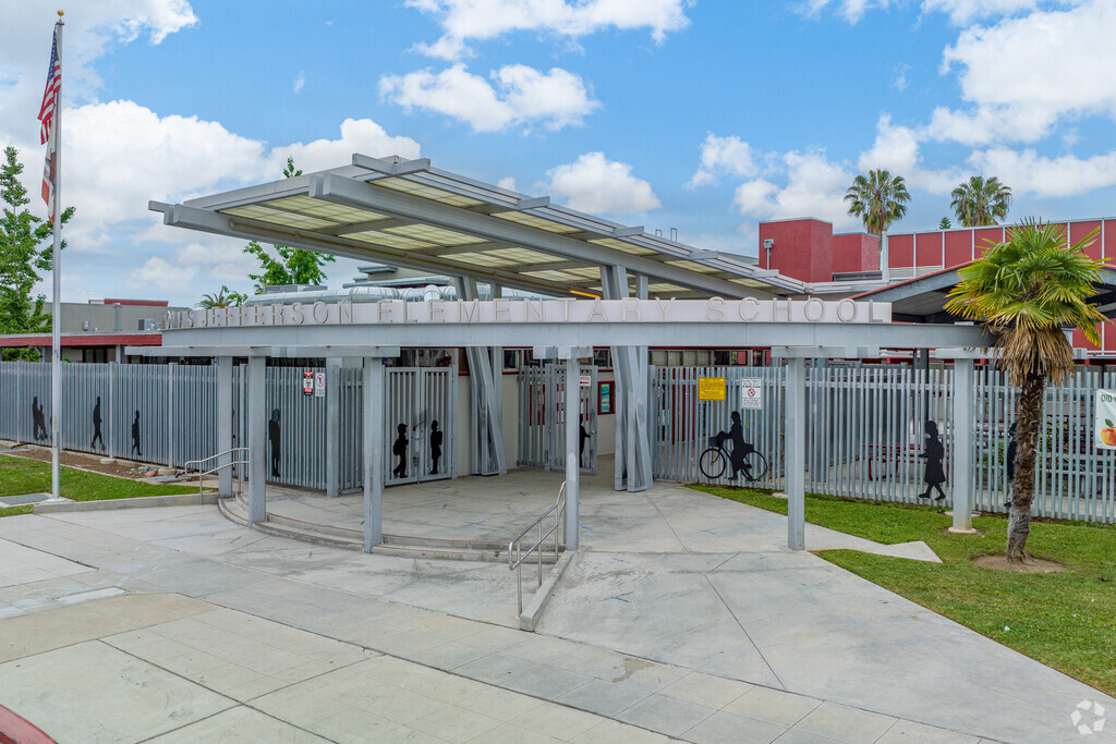 Jefferson Elementary front area with a gated entrance showing shadow drawings of students.