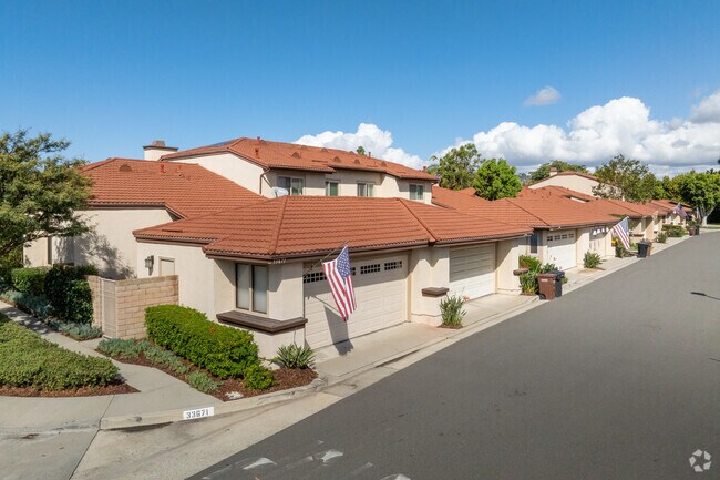 The neighborhood offers a diverse mix of real estate—from charming 1970s ranch homes to modern condos—each surrounded by lush landscaping and quiet, winding roads.