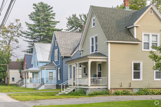 A row of New England-style homes lines Main Street in Newport, Maine.