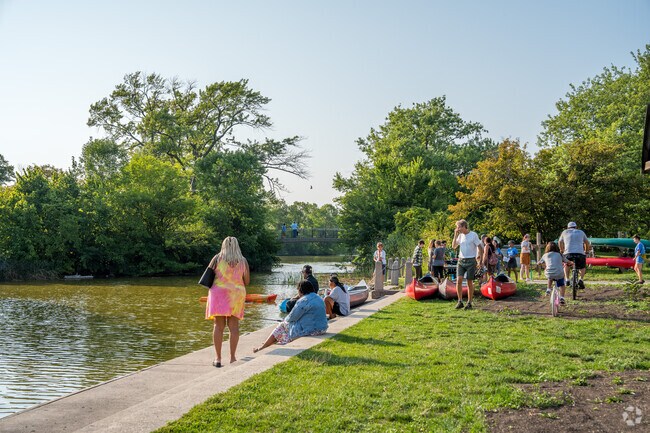 People enjoy the pond at Washington Park near the Walnut Hill Neighborhood.