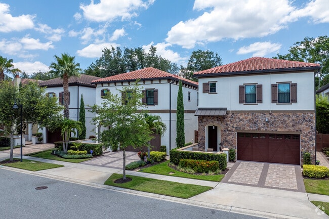 Exquisite landscaping and brick accents make this row of homes in Dr. Phillips vibrant.