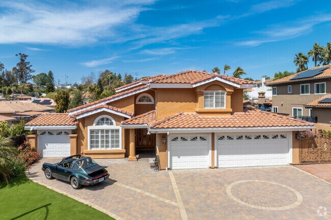 This large Spanish revival home has a three car garage.