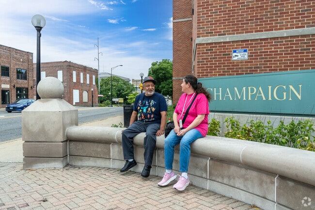 A couple sits on a bench on a nice day near the Hill Street East neighborhood.