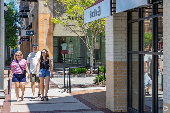A family from Carolina Heights enjoys some retail therapy at the Mayfaire Town Center.