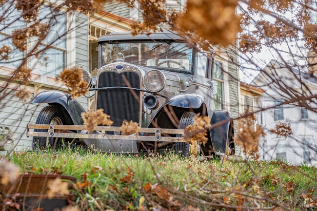 An antique car sits in front of Uniquely Yours Tea Room in Mount Pleasant Township.