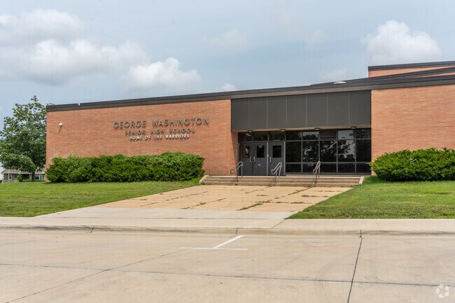 A view of the George Washington High School buildings from the street.