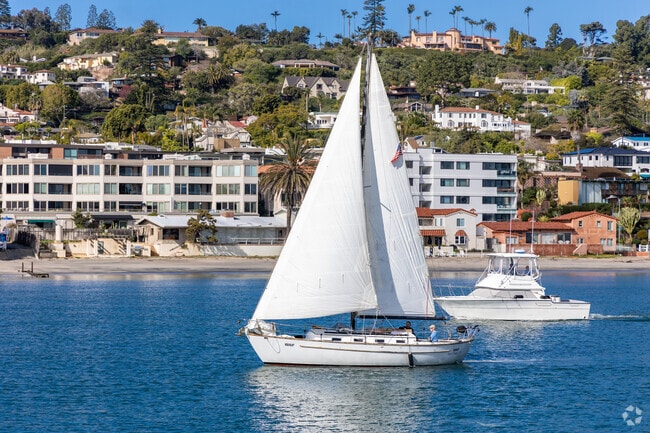 A boat sails past the condos and homes in the hills of La Playa.