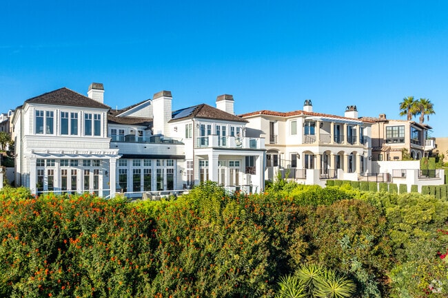 Luxurious homes are perched on cliffs in Newport Beach City with views of the Pacific ocean.