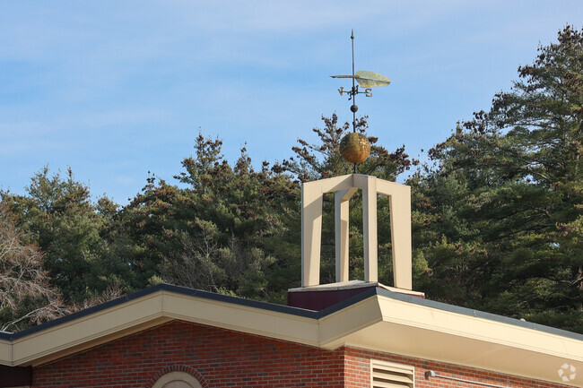A decorative weathervane tops the Steward Elementary School located in Topsfield, MA.