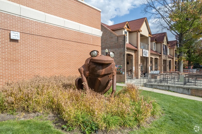 Industrial frog sculpture greets visitors at Highland Square Library.