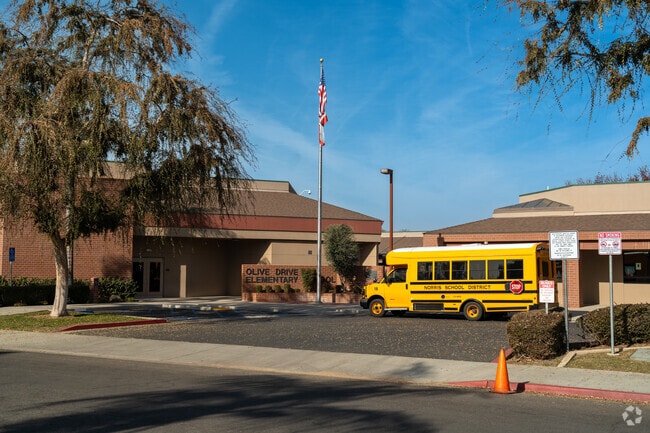 The sign at Olive Dr Elementary welcomes students as they exit the bus.