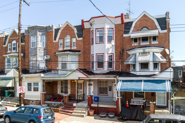 Three-story brick row houses with porches in the Allegheny West neighborhood.