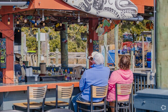 Little River locals love to sit at the outside bar and have a cold drink at the Crab Catcher's On The Waterfront.